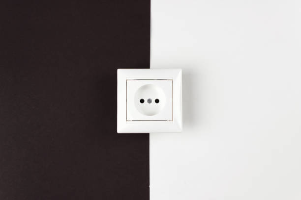 istock Energy Saving, power, electrical and lifestyle concepts. White socket on paper black and white background. Day and night Electricity tariff. 1289963523