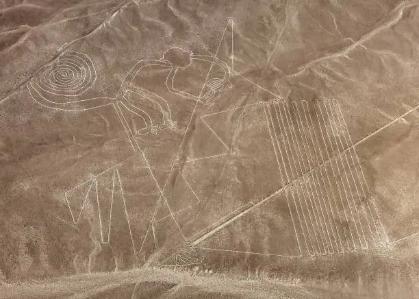 Monkey geoglyph, Nazca or Nasca mysterious lines and geoglyphs aerial view, landmark in Peru