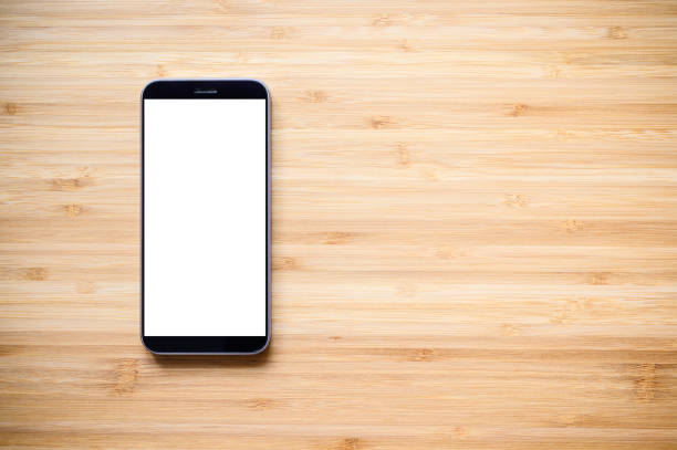 istock A smartphone with a blank display lies on an old wood 1289964315