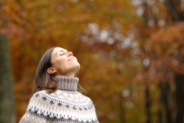 istock Middle age woman breathing deep fresh air in autumn 1289964511
