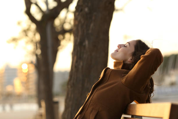 istock Profile of a woman resting on a bench in winter 1289964521