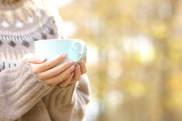 istock Woman hands holding coffee cup in winter 1289964553