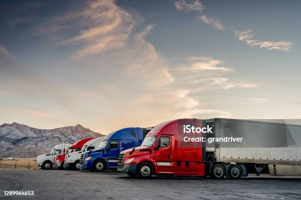 Red White And Blue Parked Trucks Lined Up At A Truck Stop Stock Photo - Download Image Now