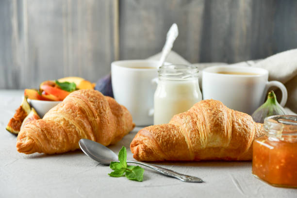 istock Breakfast coffee with milk croissants jam 1289965614