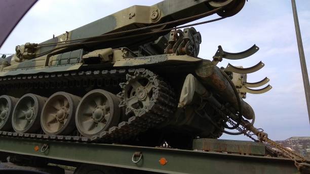 istock Partial view of a military crane mounted on caterpillar tracks, being transported. 1289967579