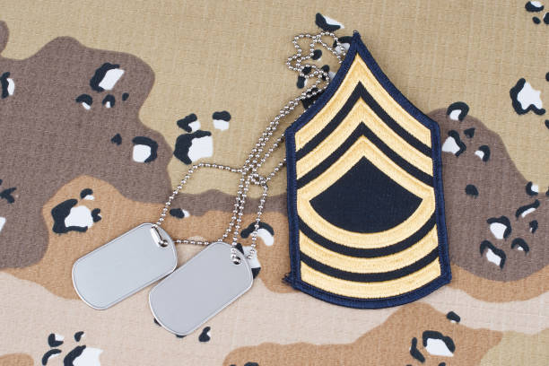 US ARMY Master Sergeant rank patch and dog tags on Desert Battle Dress Uniform US ARMY Master Sergeant rank patch and dog tags on Desert Battle Dress Uniform 1991 stock pictures, royalty-free photos & images