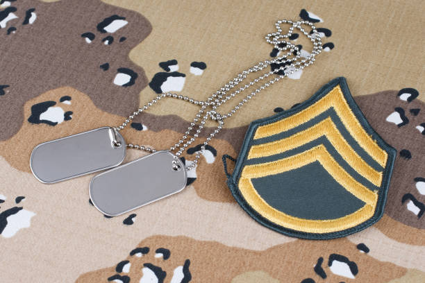 istock US ARMY Staff Sergeant rank patch and dog tags on Desert Battle Dress Uniform 1289967730