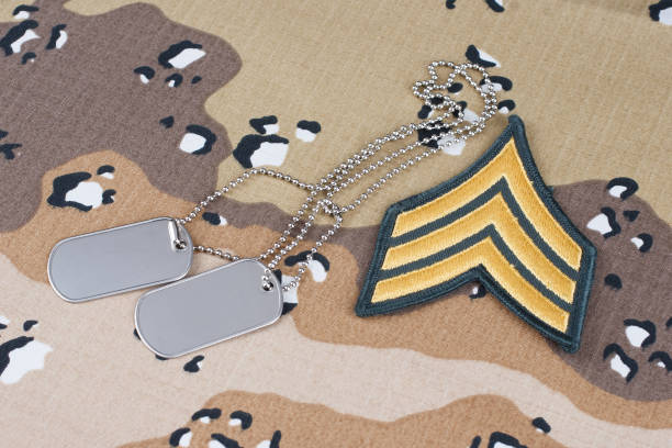 istock US ARMY Sergeant rank patch and dog tags on Desert Battle Dress Uniform 1289967742