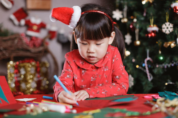 istock young girl making Christmas craft at home 1289968579