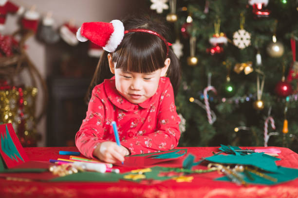 istock young girl making Christmas craft at home 1289968605