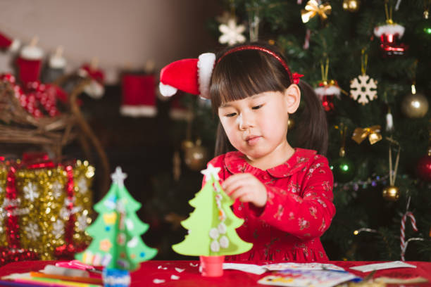 istock young girl making Christmas craft at home 1289968613