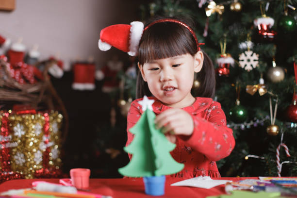 istock young girl making Christmas craft at home 1289968638