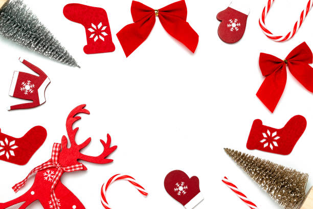 istock Christmas ornaments. Stocking, gifts, winter tree, ribbon and bow in shape frame on white background for greeting card. Flat lay, top view, copy space. 1289968723