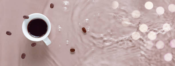 Hot coffee is splashing in cup. water and beans are blending