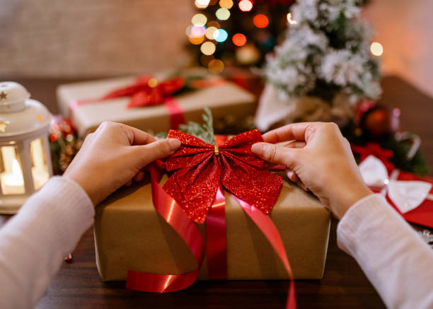 istock Woman wrapping Christmas gifts 1289969807