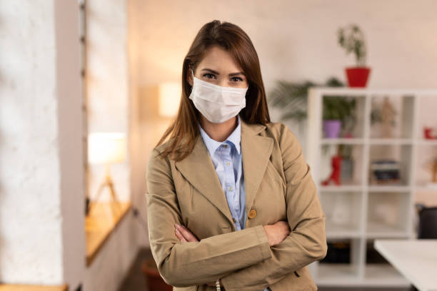 istock Cheerful woman wearing protective face mask and looking at the camera 1289971971
