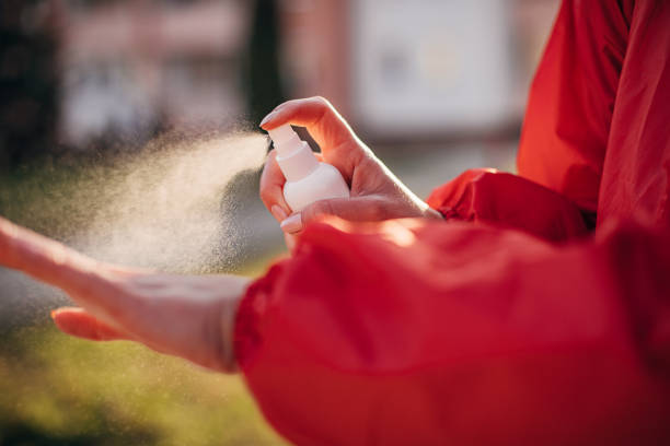 istock Female spraying hand sanitizer on hands 1289972135