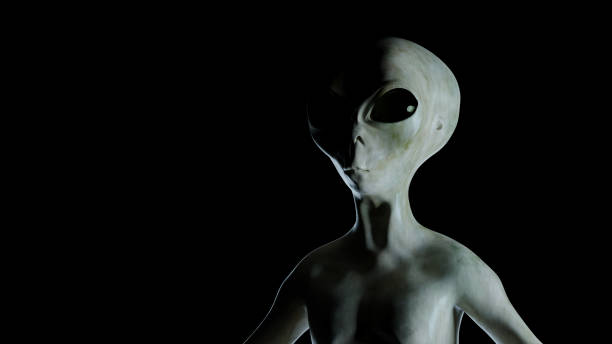 istock Spooky alien illuminated by light on black background. 3D rendered illustration. 1289973195