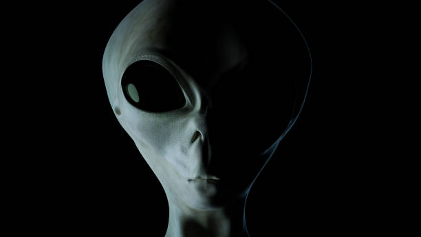 istock Alien's face on black background. UFO and extraterrestrial life concept. 3D rendered illustration. 1289973228
