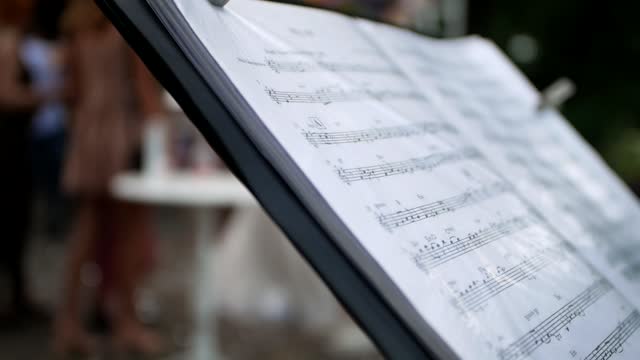 close-up of music notes placed on the music stand during a party.