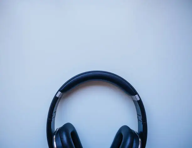 Photo of Black headphones with White background. Wireless. Musical concept