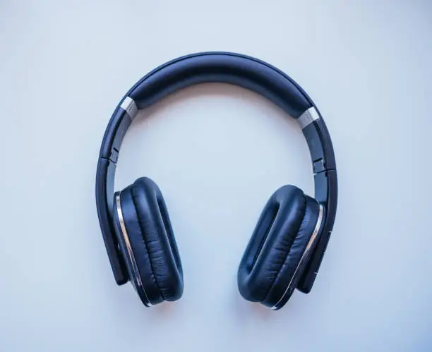 Photo of Black headphones with White background. Wireless. Musical concept