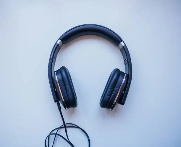 Photo of Black headphones with White background.  Musical concept