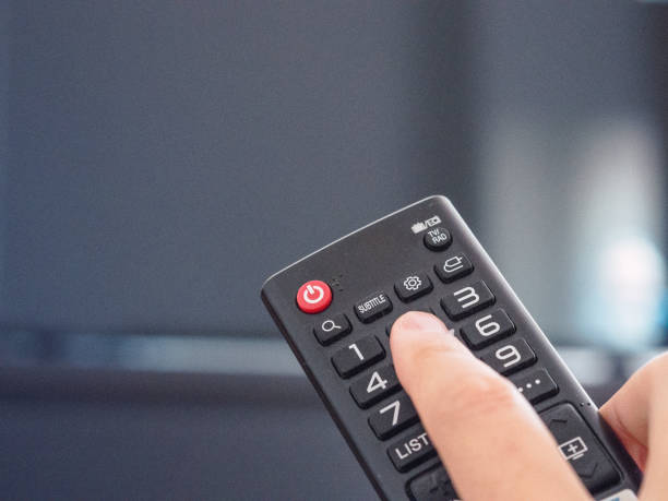 istock A hand holding a remote control. Program TV, breaking news. Multimedia concept 1289974299