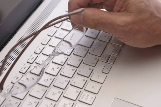 istock Laptops and glasses in senior hands 1289977165