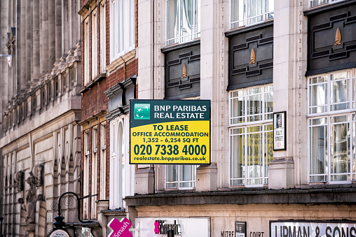 London, UK - June 22, 2018: Fleet street road in center of downtown city with sign for BNP Paribas Real Estate office lease and phone number