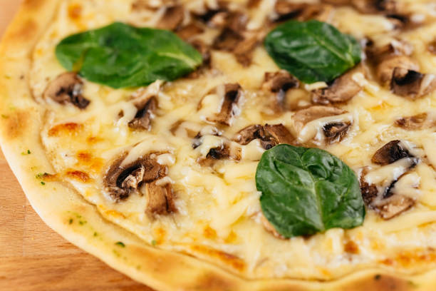 istock Italian pizza on a wooden Board and light background 1289979412