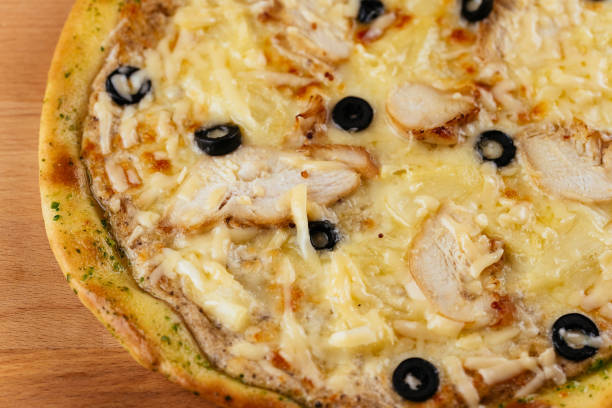 istock Italian pizza on a wooden Board and light background 1289979986