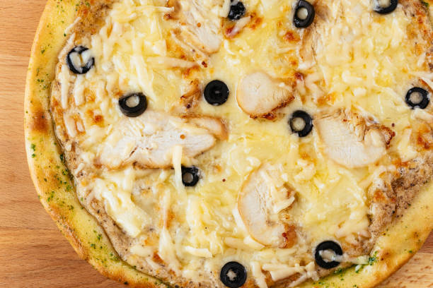 istock Italian pizza on a wooden Board and light background 1289979991