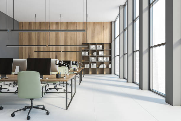 istock Open space office with computers and green chairs, a bookshelf on a white floor 1289980230