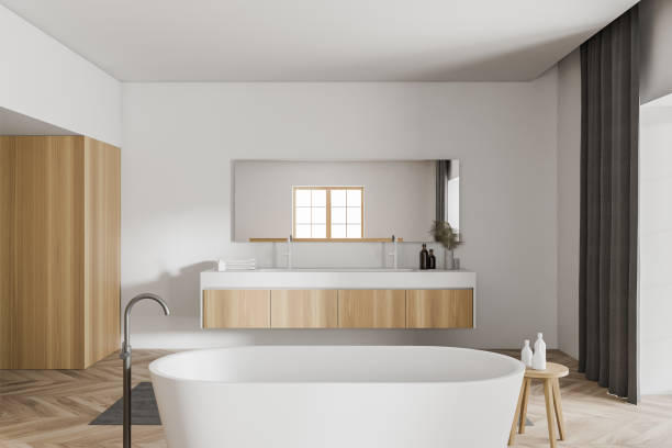 istock Modern white and wooden bathroom interior with tub and sink 1289980345