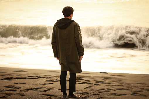 A man looking at the sea alone