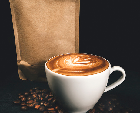 Coffee package with a glass of cappuccino - Studio Shot - Black Background