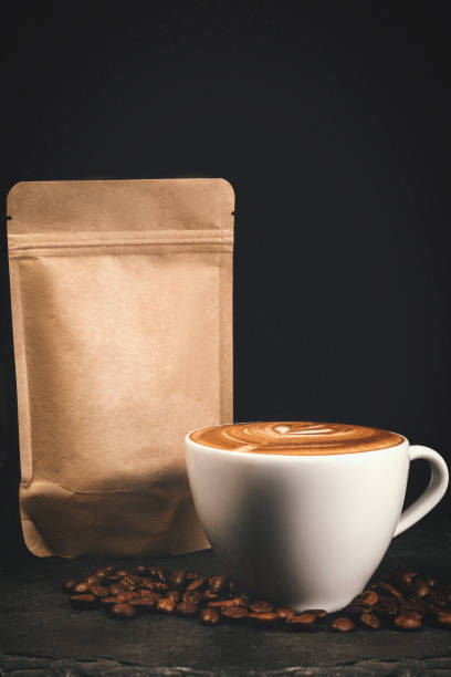 istock Coffee package with a glass of cappuccino - Studio Shot - Black Background 1289983018