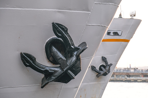 Raised and fixed anchor, cruise ships at the dock