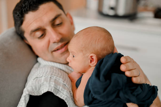 istock Father cares for newborn som 1289985023