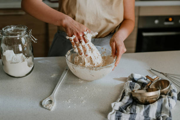 istock Home Hobbies: Hands of an Anonymous Woman Baking Sourdough Bread from Scratch - the Kneading Phase 1289989234