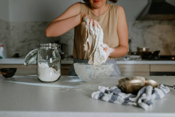 istock Home Hobbies: Hands of an Anonymous Woman Baking Sourdough Bread from Scratch - the Kneading Phase 1289989240