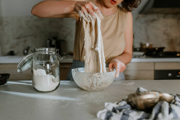 Home Hobbies: Hands of an Anonymous Woman Baking Sourdough Bread from Scratch - the Kneading Phase