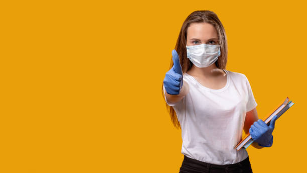istock school reopen new normal teacher mask thumb up 1289990277
