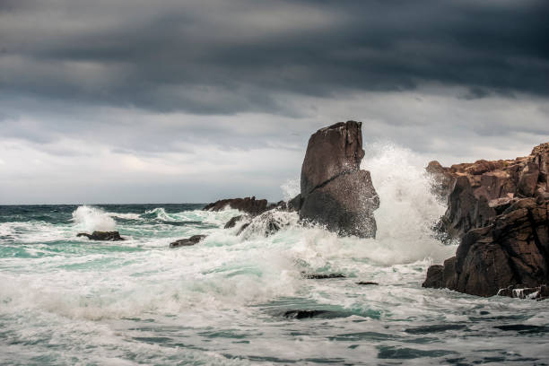 istock Powerful waves crashes in rocky coastline 1289990313