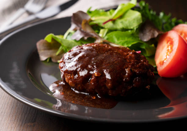 istock Hamburger with demi-glace sauce served on a plate placed on the table 1289991608