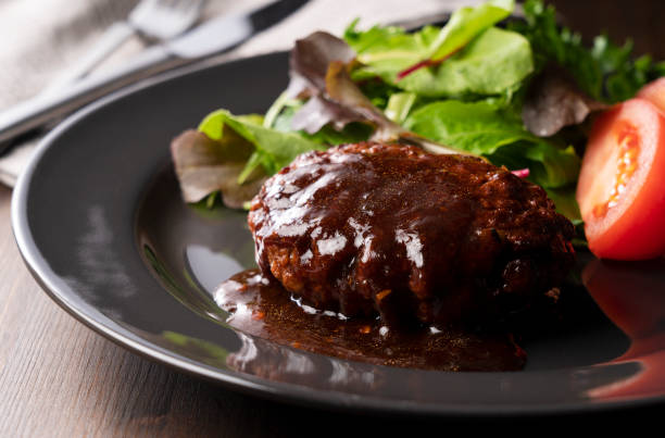 istock Hamburger with demi-glace sauce served on a plate placed on the table 1289991684