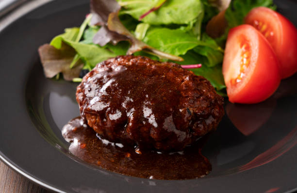 istock Hamburger with demi-glace sauce served on a plate placed on the table 1289991886
