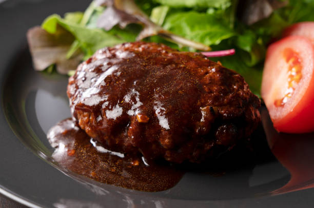 istock Hamburger with demi-glace sauce served on a plate placed on the table 1289991937