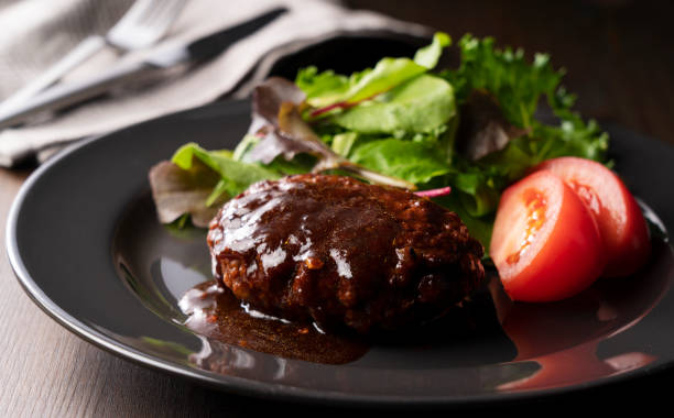 istock Hamburger with demi-glace sauce served on a plate placed on the table 1289992574